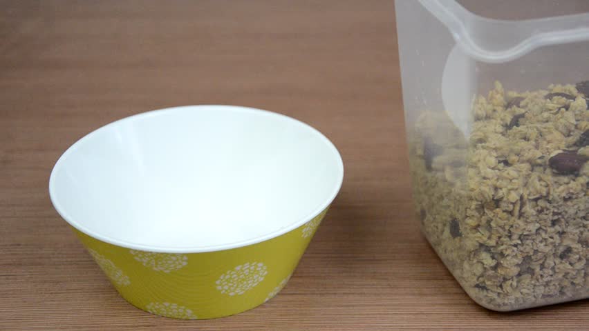 Pouring cornflakes into a bowl