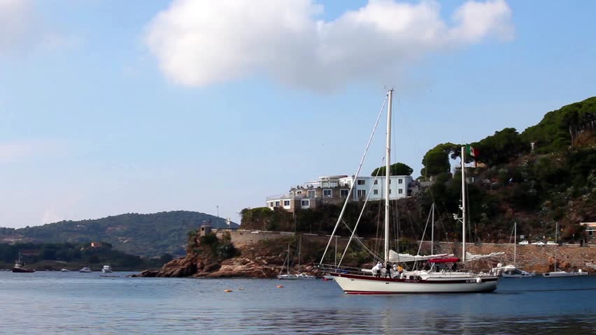 a sailboat getting out of the port. Porto Azzurro, Elba Island, Italy.