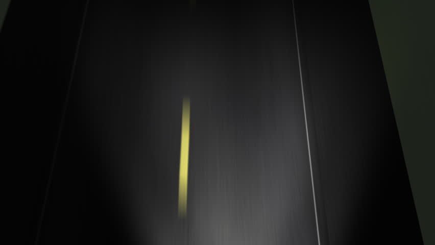 Driving down the road, looking down at night time..