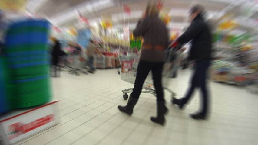 People walk and are engaged in purchases in shopping centre, time lapse