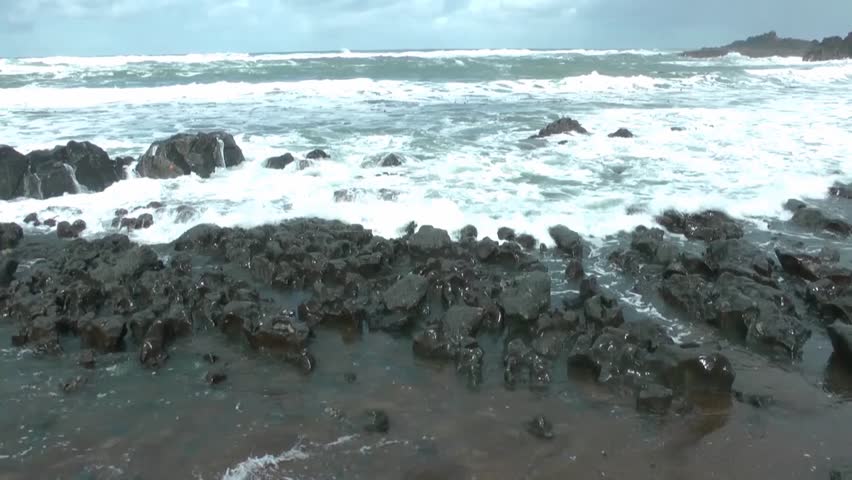 waves crashing onto a rocky shore