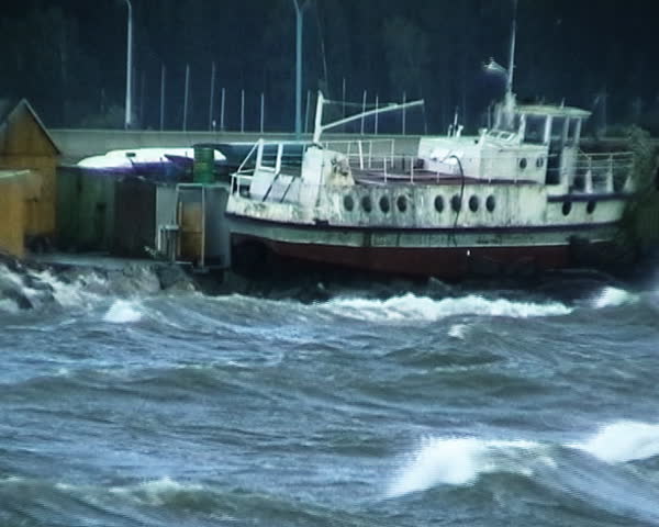 Storm. Raw waves, ugly wind, rusty boat.