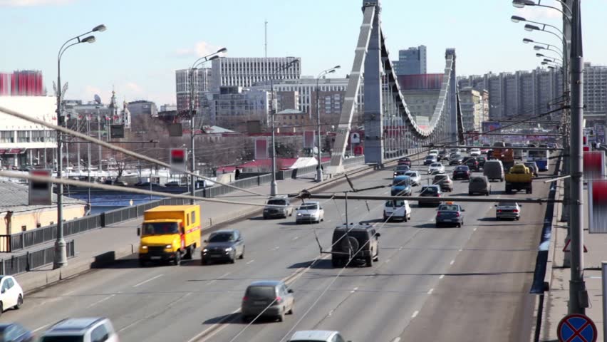 Many cars ride over Crimean Bridge in Moscow at sunny winter day