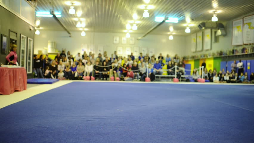 Talented gymnast performs floor exercise during competition.
