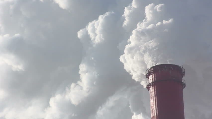 Industrial chimney belching out clouds of smoke into the atmosphere in an air pollution concept