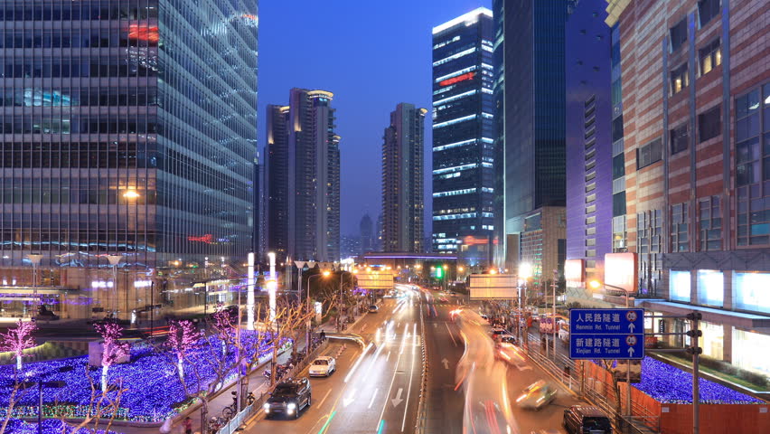 city traffic on the modern building background in Shanghai Pudong, China. timelapse