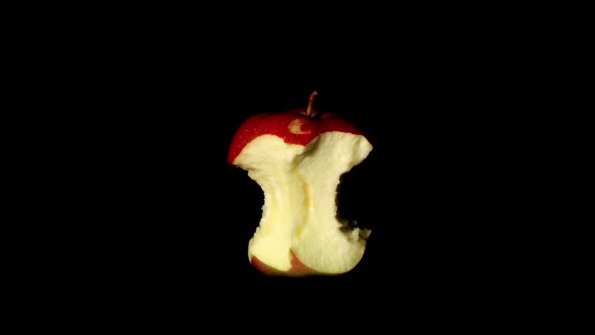 Timelapse of apple core decaying on the black background
