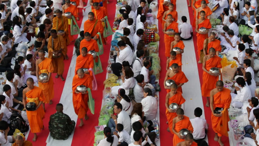 BANGKOK - MARCH 17: Monks are participating in a Mass Alms Giving of 12,600 monks in Saphan Khwai for the Makha Bucha celebrations on March 17, 2012 in Bangkok, Thailand.