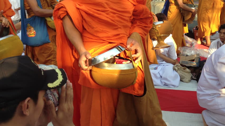 BANGKOK - MARCH 17: Monks are participating in a Mass Alms Giving of 12,600 monks in Saphan Khwai for the Makha Bucha celebrations on March 17, 2012 in Bangkok, Thailand.