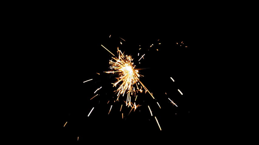 Sparkler Over Black (HD). Gun powder sparks shot against deep dark background. Ambient audio included. Slow Motion. 
