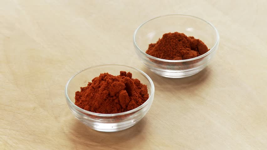 Bowls of paprika being taken