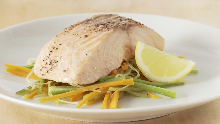 Steamed salmon being served with a foamy sauce