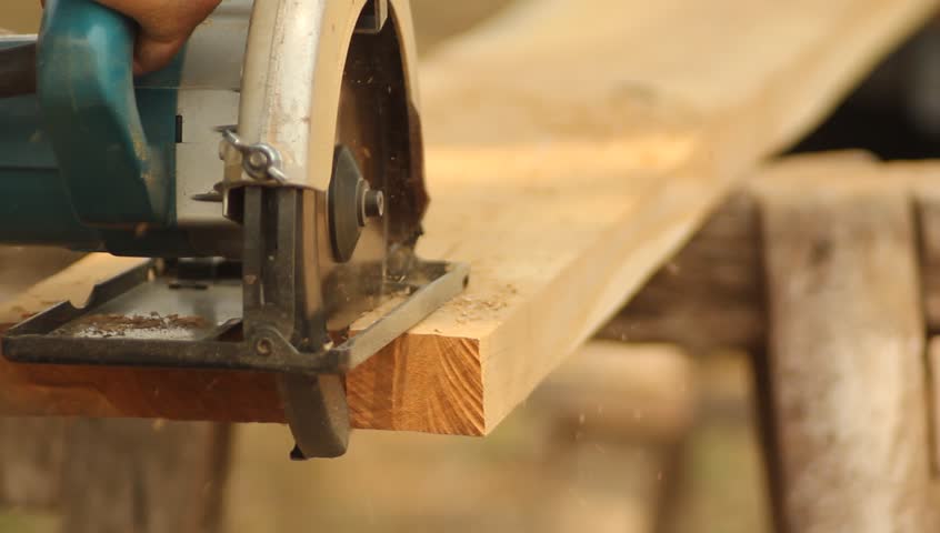 Cutting wooden floor by electric saw
