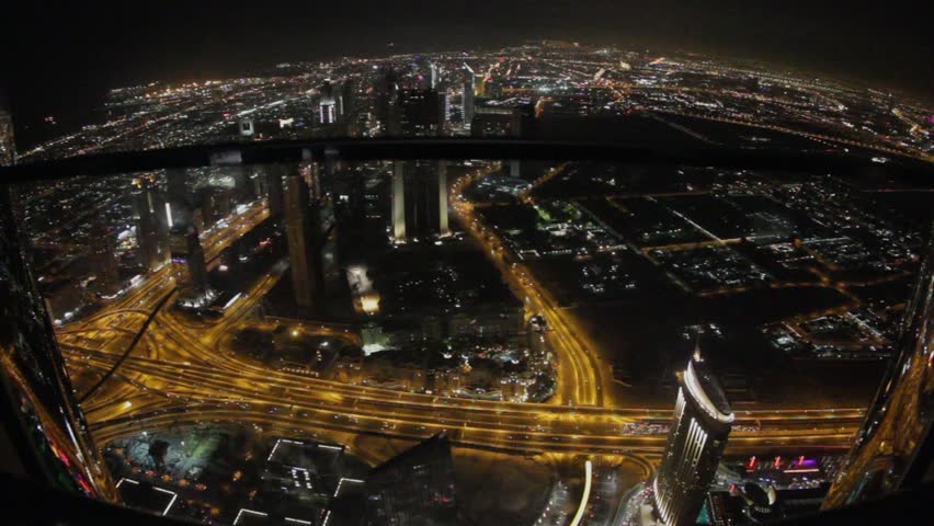 panoramic view from the top to the night lights and traffic flow on flyover in Dubai, UAE