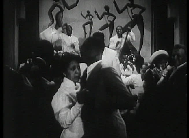 Band leader conducting musicians in1930s nightclub