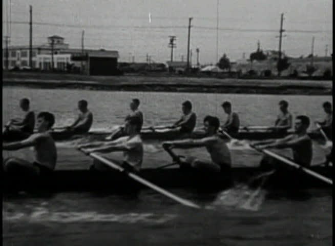 Close-up of men rowing in racing contest
