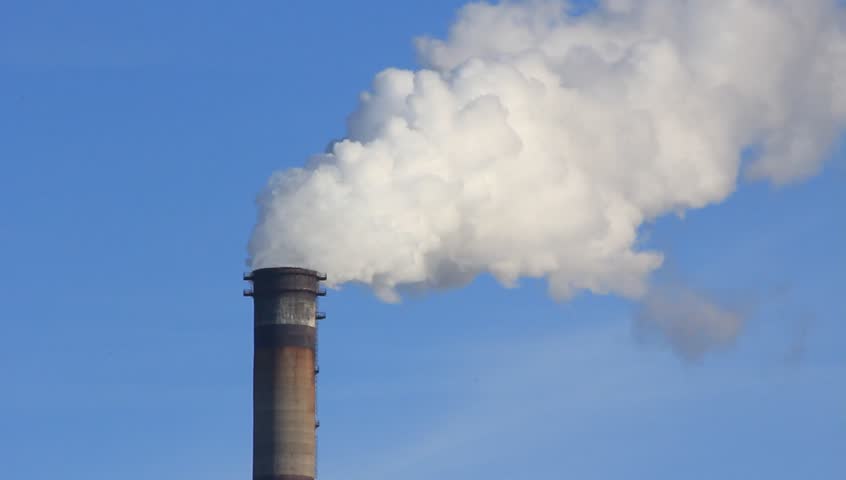 Smoke spews from an industrial smokestack