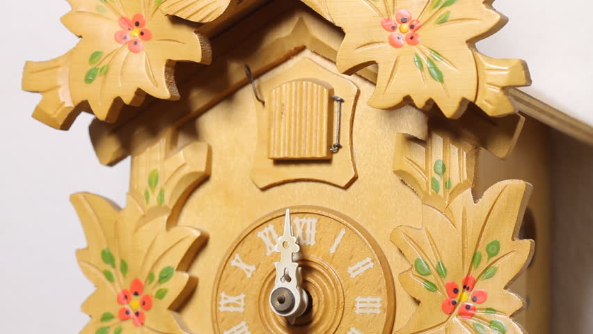 Cuckoo Clock Twelve Chimes (HD). Vintage style Cuckoo clock chimes twelve times showing bird while camera changes angles from the ticking pendulum to the house bird. Audio included.