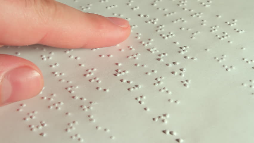 Male Hand Reading Braille. Male hand reading braille dot language for the Blind. 