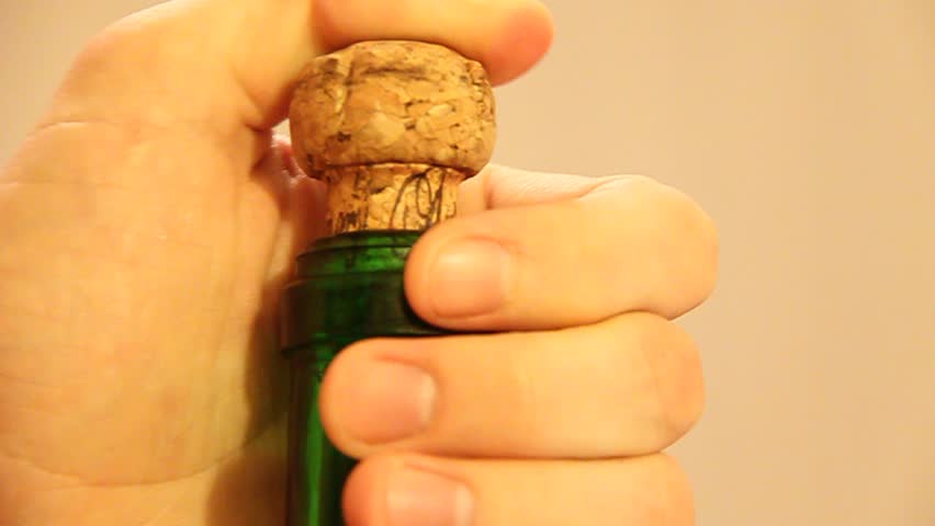 Popping a cork on a champagne bottle