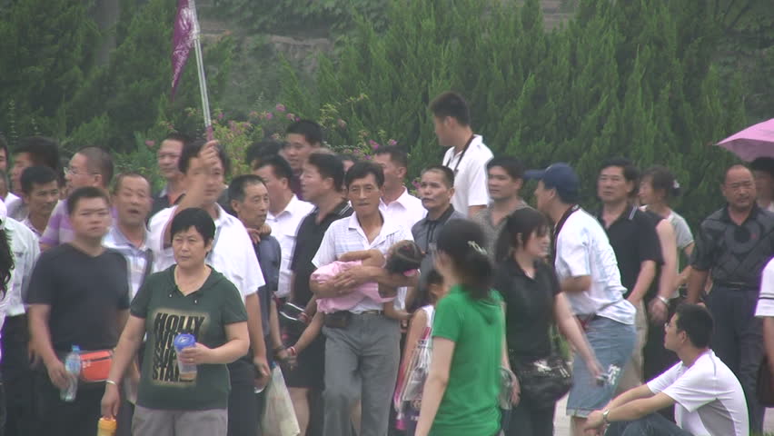 XIAN - 15 JULY 2010: Chinese tourists make their way to the Terracotta Army in Xian