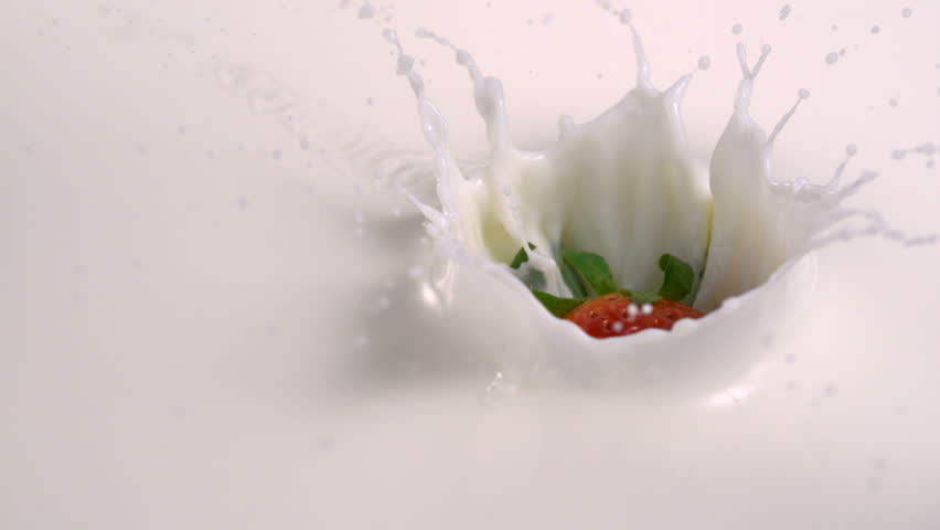 Slo-mo strawberry into milk