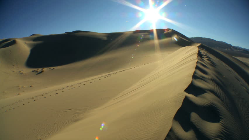 Time lapse of the setting sun on desert sand dunes