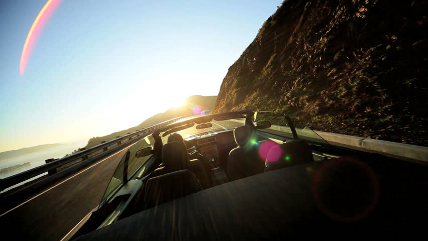 Californian road trip driving a Cabriolet on a winding Pacific highway