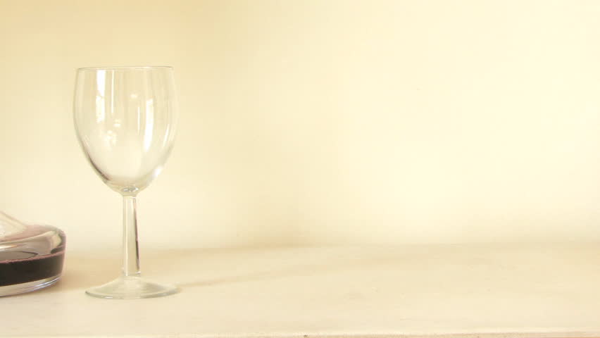 MEDIUM SHOT PAN WINE GLASS AND DECANTER