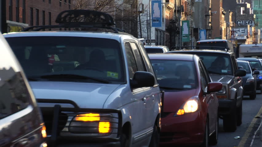 Traffic jam moves slowly. Heavy congestion on the lower east side of Manhattan due to construction at dusk. 