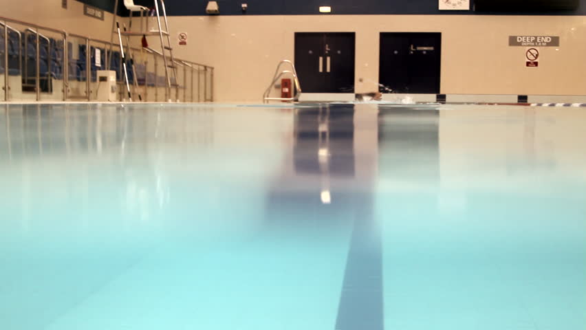 Male swimming in swimming pool in gym