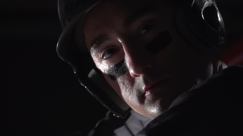 Close up of a baseball players face as he bats