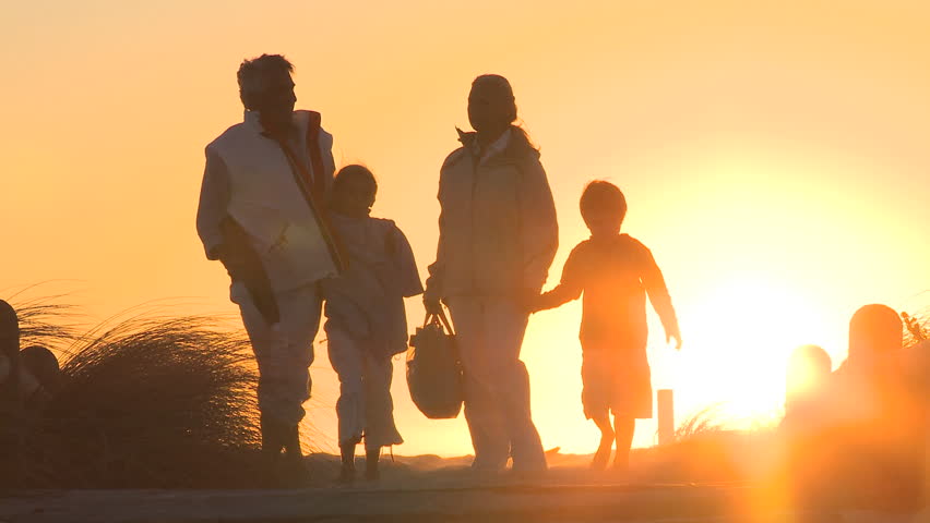 LONG SHOT VIEW OF GRANDPARENTS WALKING ALONG A PATH WITH THEIR GRANDCHILDREN