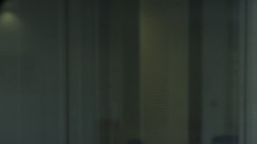 CLOSE UP PAN FEMALE ON PHONE IN OFFICE