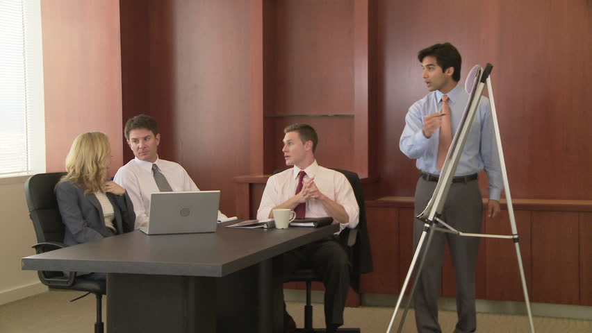 Young business man making presentation to coworkers