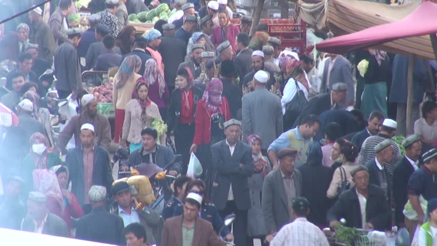 KASHGAR - 19 SEPTEMBER 2010: People are trading, selling, buying at the busy bazaar of Kashgar, China. The city has a very important Sunday market that attracts thousands of vendors. 