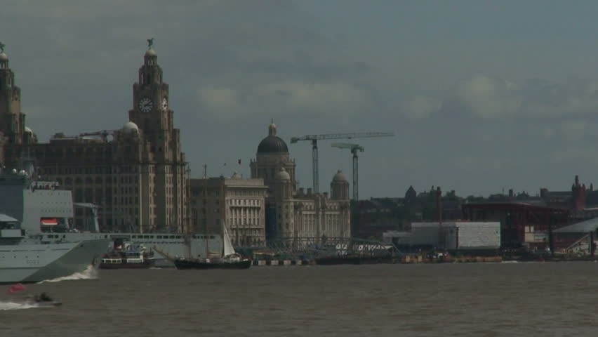 Royal Navy ship and old tall ships in the River Mersey Liverpool UK July 2008
