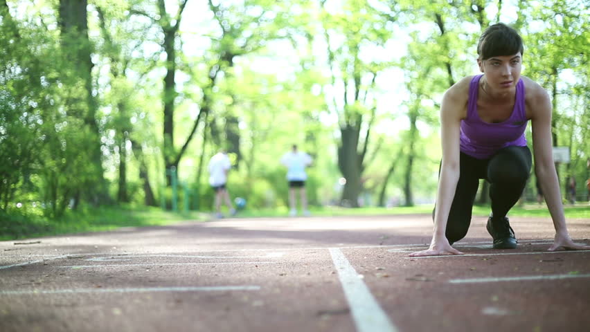 Young beautiful woman preparing to run, dolly shot
