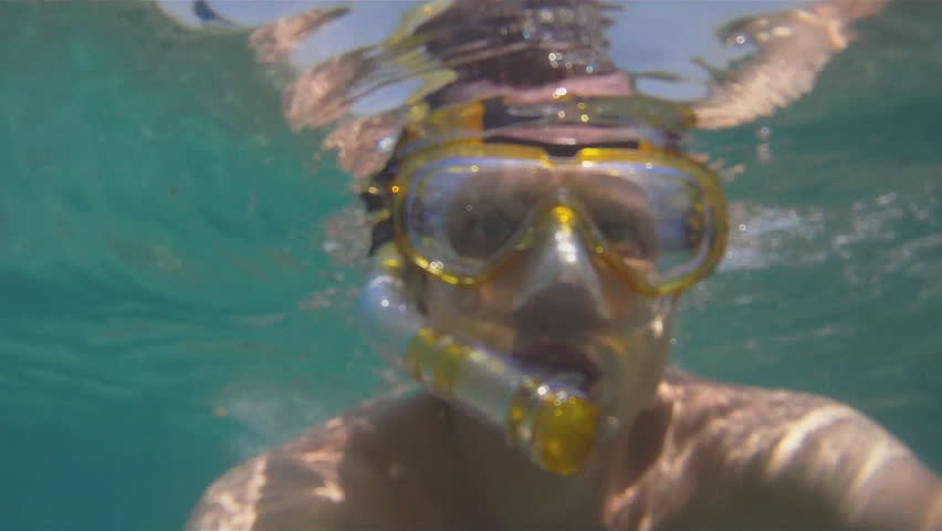 Man swims with the mask in the Red Sea