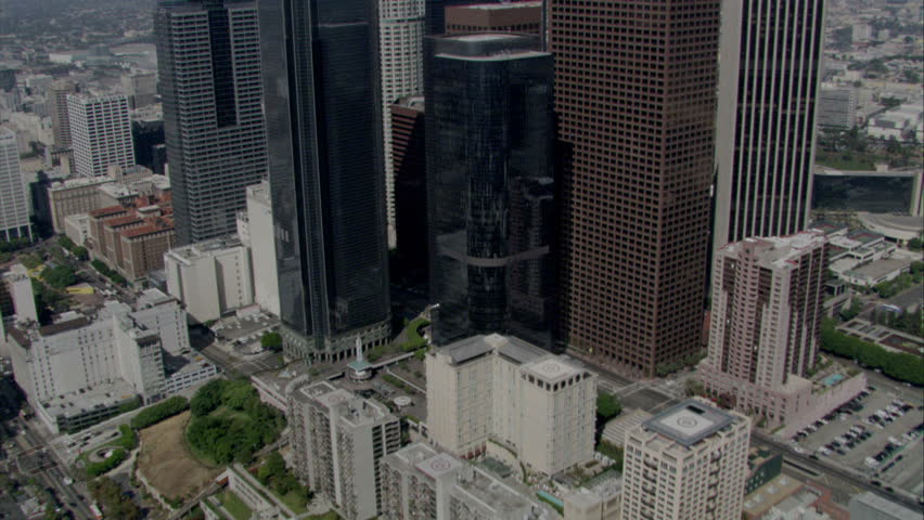 Aerial flying shot over and between skyscrapers in Los Angeles downtown area circa 2009