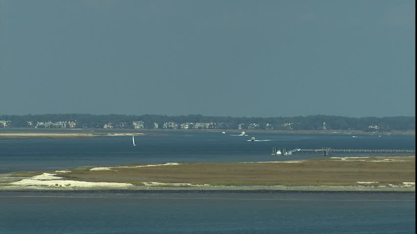 coastal waterways with boats and homes in the distance