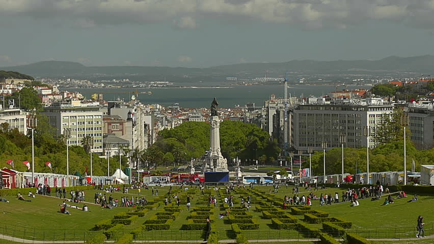 Time lapse of people walking in a park of Lisbon, Portugal. River Tagus as background.