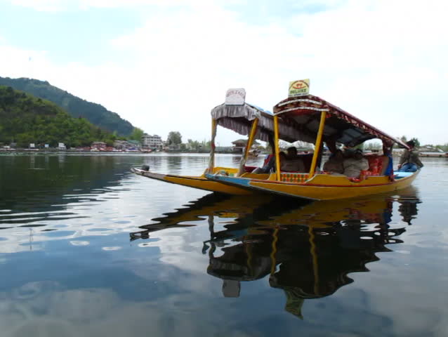 SRINAGAR, INDIA - APRIL 14: Tourists take a boat around the lake on April 14, 2012 in Dal Lake, Srinagar, Jammu and Kashmir, India.
