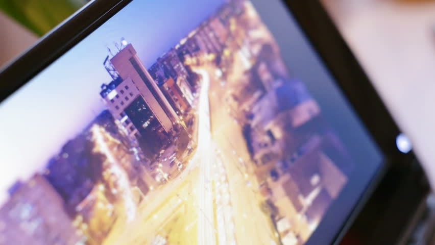 looking at photograph of a city on digital tablet-pc