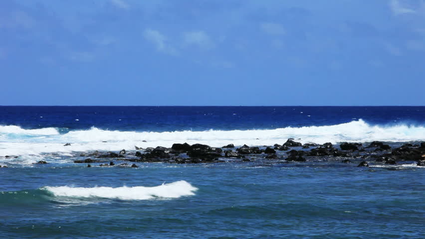 Ocean waves on a small rocky inlet cove