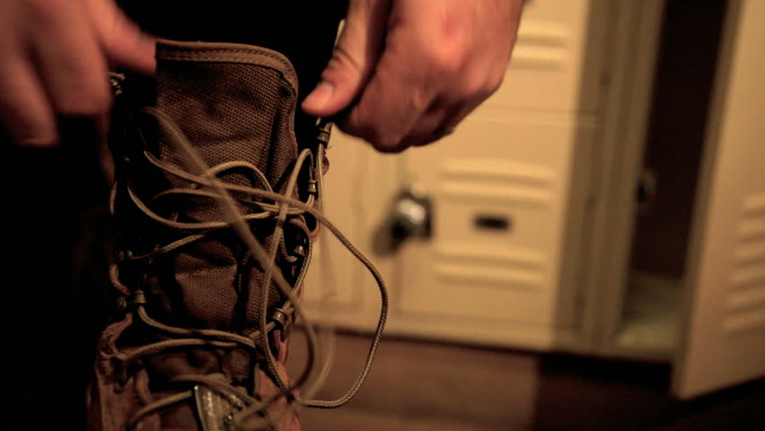 close up of pilot lacing up boots