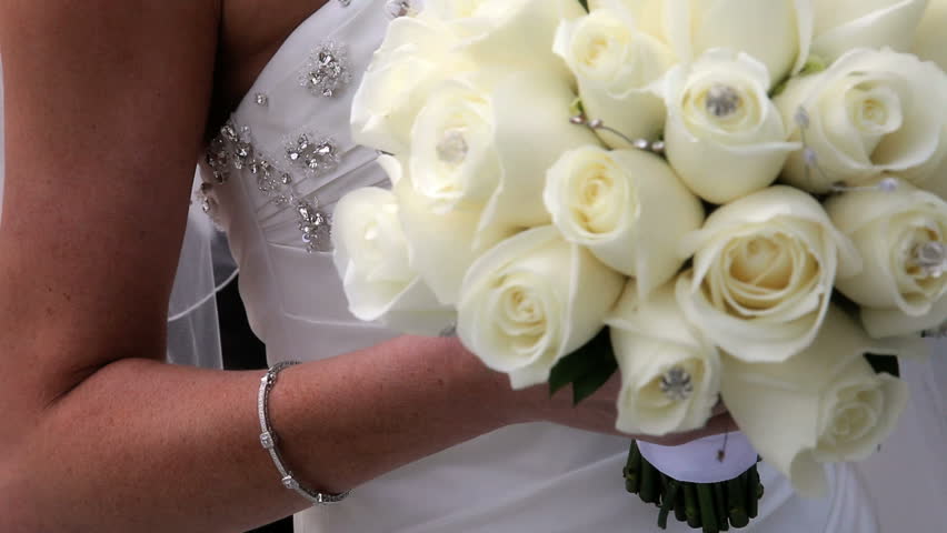 bouquet of beautiful white roses held by bride