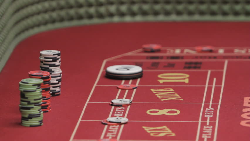 gambler sets up bet on a crap table