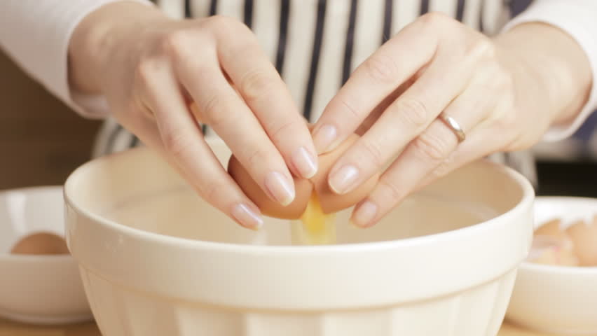 Woman cracking egg
