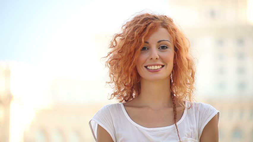 Excited adult pretty young woman air quotes and smiles.
